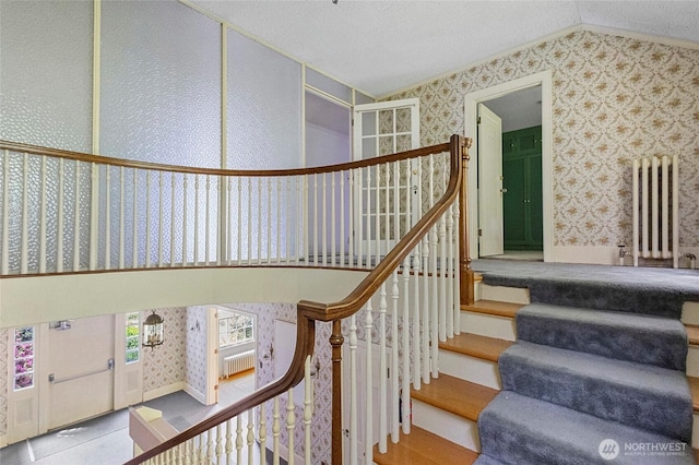 46372 E Main St, Concrete, WA 98237 - stairs featuring radiator, wallpapered walls, and vaulted ceiling
