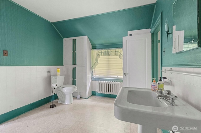 46372 E Main St, Concrete, WA 98237 - bathroom with radiator heating unit, tile walls, tile patterned floors, a wainscoted wall, and lofted ceiling