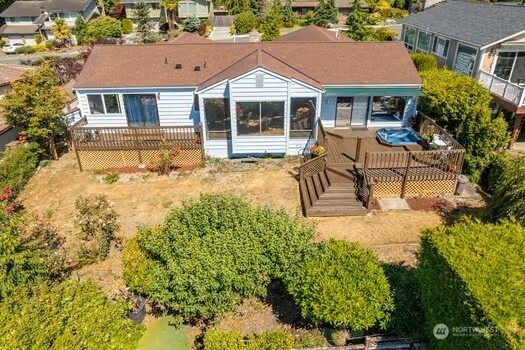 28635 11th Ave S, Federal Way, WA 98003 - rear view of house featuring a wooden deck and a sunroom
