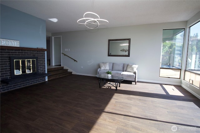 28635 11th Ave S, Federal Way, WA 98003 - living room featuring wood finished floors, stairs, a fireplace, and a chandelier