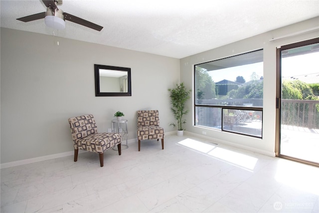 28635 11th Ave S, Federal Way, WA 98003 - living area with marble finish flooring, a textured ceiling, and a ceiling fan