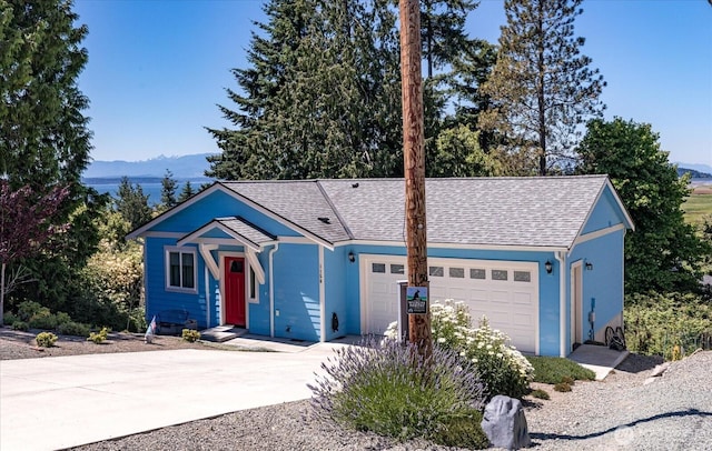1156 Halsey Ave, Coupeville, WA 98239 - single story home featuring a mountain view, a garage, concrete driveway, and roof with shingles