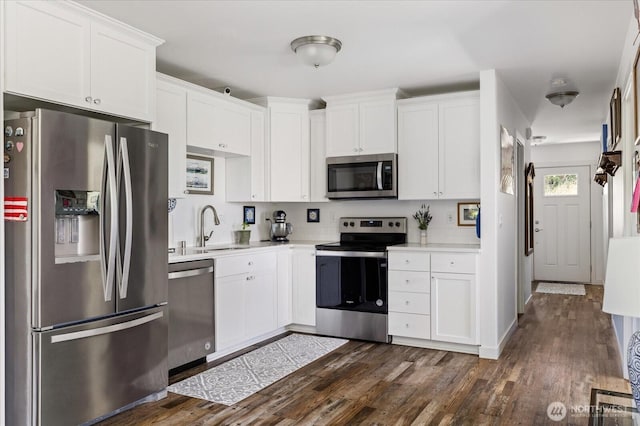 1156 Halsey Ave, Coupeville, WA 98239 - kitchen with appliances with stainless steel finishes, light countertops, dark wood-type flooring, and white cabinets