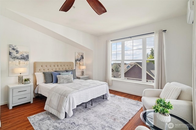 1899 NE Kenyon Ct, Issaquah, WA 98029 - bedroom featuring a wall unit AC, dark wood finished floors, and ceiling fan