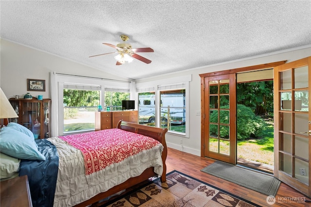 472 Iris Ln, Camano Island, WA 98282 - bedroom featuring access to outside, vaulted ceiling, wood finished floors, a textured ceiling, and ceiling fan