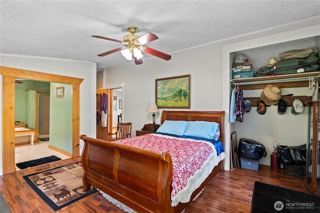 472 Iris Ln, Camano Island, WA 98282 - bedroom with wood finished floors, a textured ceiling, crown molding, and ceiling fan