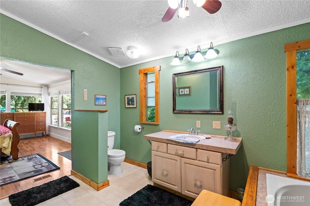 472 Iris Ln, Camano Island, WA 98282 - bathroom with a ceiling fan, a textured wall, a textured ceiling, vanity, and lofted ceiling