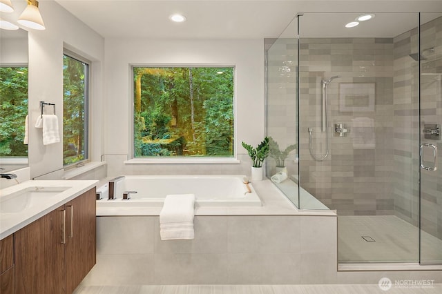 10915 126th Pl NE, Kirkland, WA 98033 - bathroom featuring vanity, a bath, a stall shower, and recessed lighting