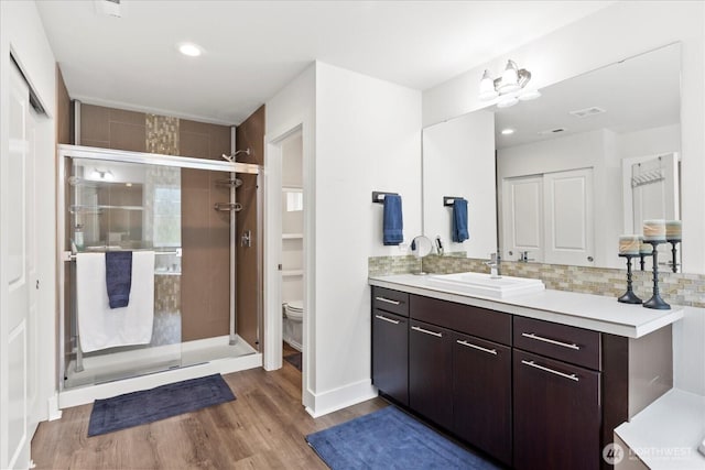 6010 155th St SW, Edmonds, WA 98026 - full bathroom featuring vanity, a stall shower, wood finished floors, tasteful backsplash, and recessed lighting