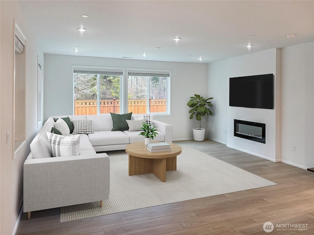 17911 139th Pl E, Puyallup, WA 98374 - living area with wood finished floors, recessed lighting, and a glass covered fireplace