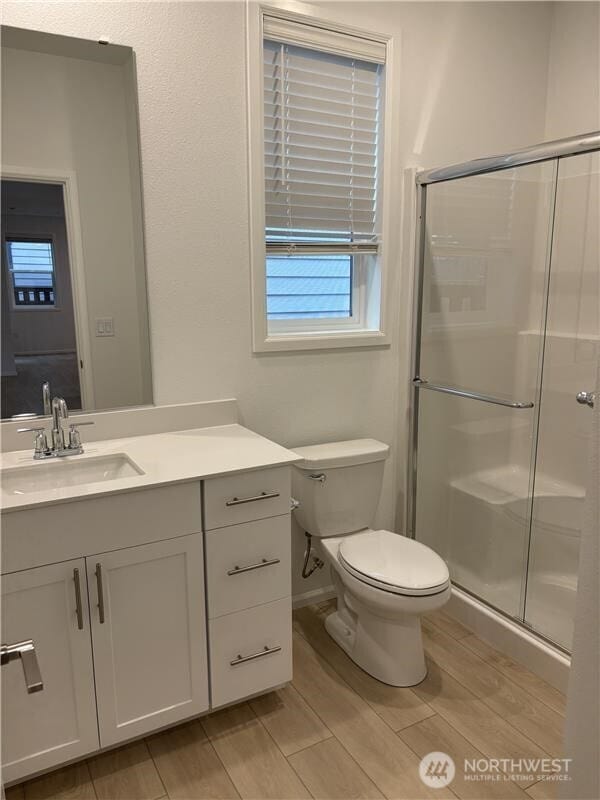 17911 139th Pl E, Puyallup, WA 98374 - full bathroom with vanity, a shower stall, and wood finish floors