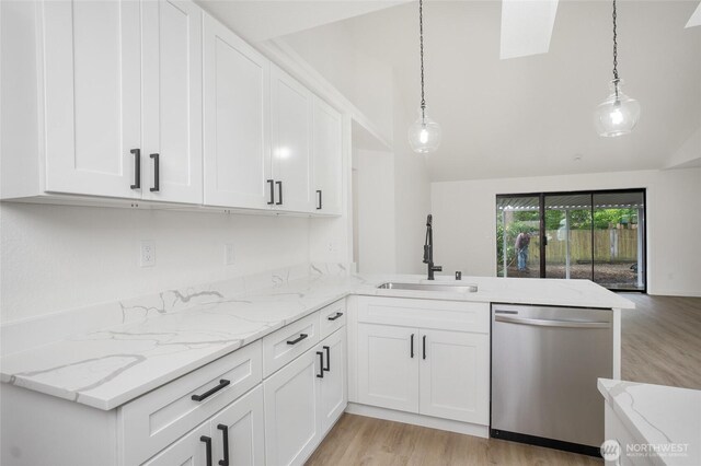 1308 133rd St S, Tacoma, WA 98444 - kitchen featuring stainless steel dishwasher, a peninsula, light wood-style floors, lofted ceiling, and white cabinetry