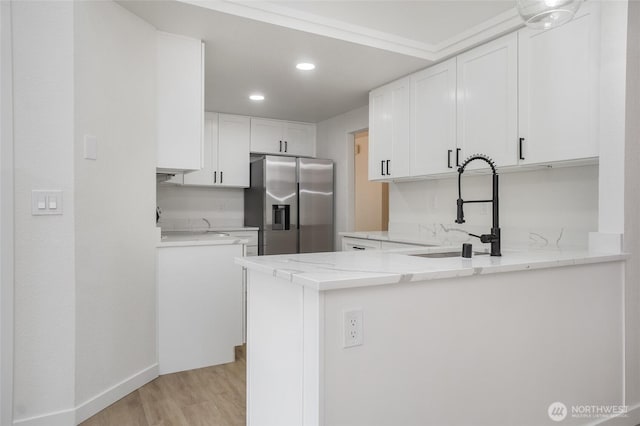 1308 133rd St S, Tacoma, WA 98444 - kitchen featuring stainless steel refrigerator with ice dispenser, light wood-type flooring, a peninsula, white cabinetry, and light stone countertops