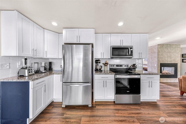 6008 S Bakerview Park Dr, Ferndale, WA 98248 - kitchen with stainless steel appliances, tasteful backsplash, light stone counters, white cabinets, and recessed lighting