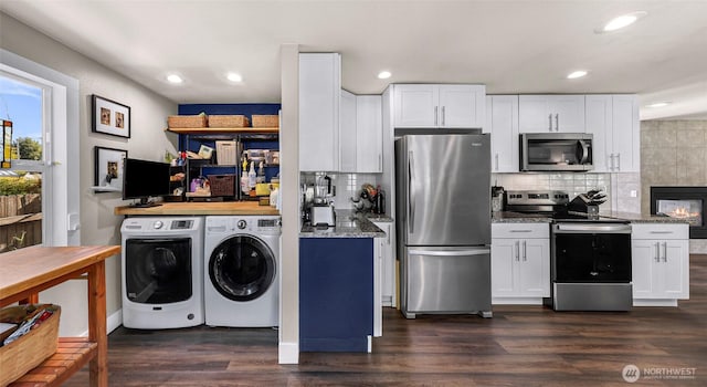6008 S Bakerview Park Dr, Ferndale, WA 98248 - kitchen featuring appliances with stainless steel finishes, independent washer and dryer, backsplash, white cabinetry, and recessed lighting