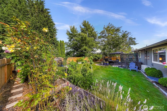 6008 S Bakerview Park Dr, Ferndale, WA 98248 - fenced backyard with a patio, a vegetable garden, outdoor lounge area, and a gazebo