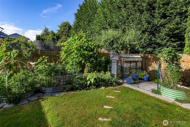 6008 S Bakerview Park Dr, Ferndale, WA 98248 - fenced backyard featuring a garden, an exterior structure, and an outdoor structure