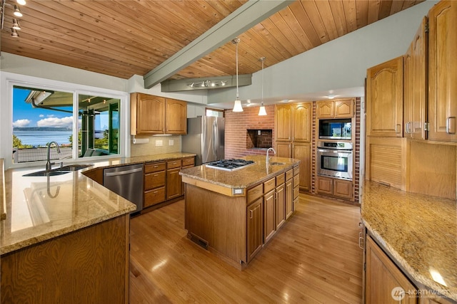 29812 Marine View Dr SW, Federal Way, WA 98023 - kitchen featuring appliances with stainless steel finishes, light wood-type flooring, a center island with sink, light stone countertops, and a wood ceiling with exposed beams