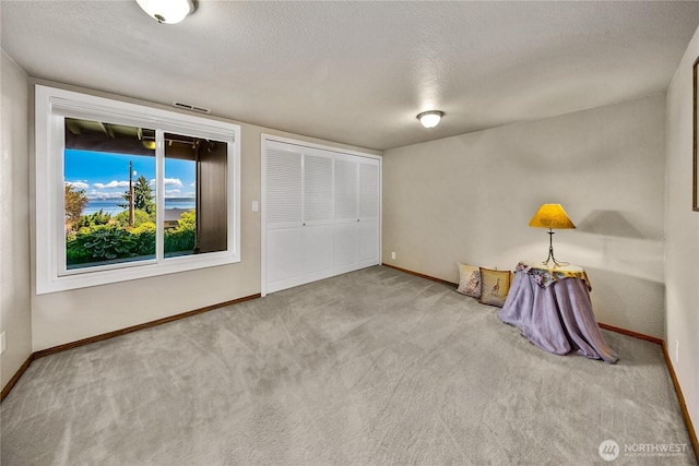 29812 Marine View Dr SW, Federal Way, WA 98023 - unfurnished bedroom with a textured ceiling, carpet flooring, and a closet
