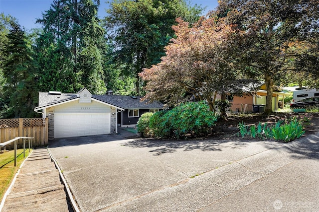 21313 2nd Dr SE, Bothell, WA 98021 - view of front of house featuring stone siding, a garage, and driveway