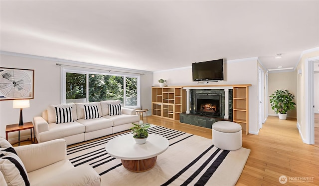 21313 2nd Dr SE, Bothell, WA 98021 - living area with ornamental molding, light wood-style floors, and a high end fireplace