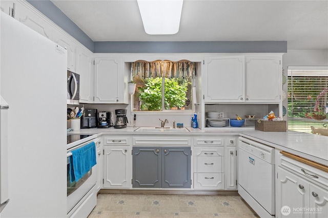 23019 Arlington Heights Rd, Arlington, WA 98223 - kitchen featuring white appliances, plenty of natural light, white cabinetry, and light countertops