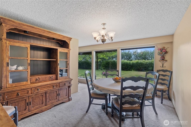 23019 Arlington Heights Rd, Arlington, WA 98223 - dining room featuring light carpet, a chandelier, and a textured ceiling