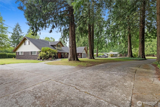 23019 Arlington Heights Rd, Arlington, WA 98223 - view of front facade with driveway, a front yard, and brick siding