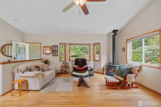 23019 Arlington Heights Rd, Arlington, WA 98223 - living area with a wood stove, wood finished floors, a ceiling fan, and lofted ceiling