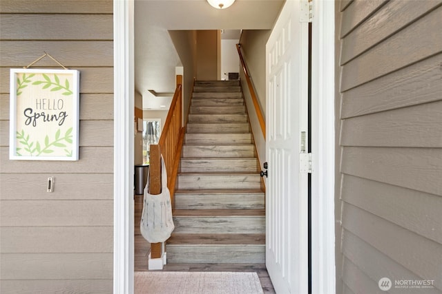 2427 Spruce Rd, Lake Stevens, WA 98258 - staircase with wooden walls and wood finished floors