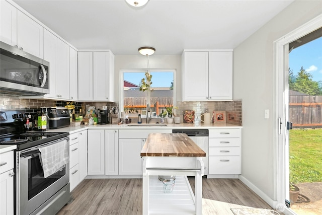 2427 Spruce Rd, Lake Stevens, WA 98258 - kitchen with appliances with stainless steel finishes, butcher block counters, decorative backsplash, and light wood finished floors
