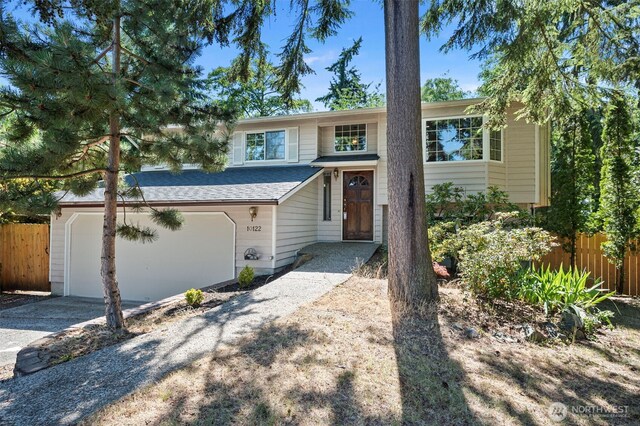 10122 50th Pl W, Mukilteo, WA 98275 - bi-level home with driveway, roof with shingles, and an attached garage