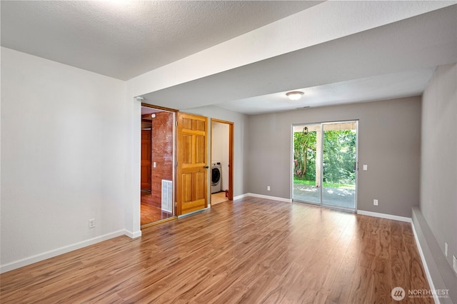10122 50th Pl W, Mukilteo, WA 98275 - spare room with light wood-style floors and washer / clothes dryer