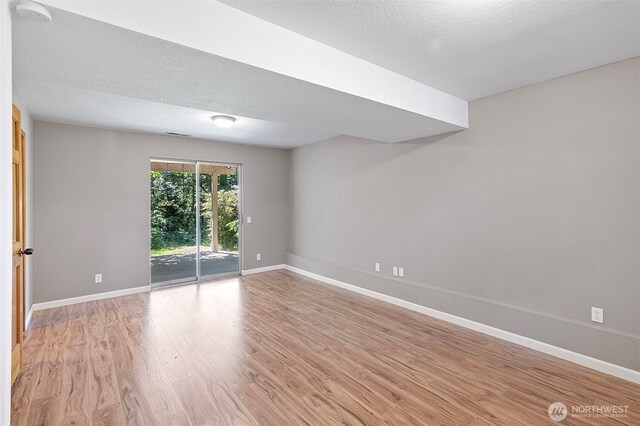10122 50th Pl W, Mukilteo, WA 98275 - empty room with light wood-style flooring and a textured ceiling