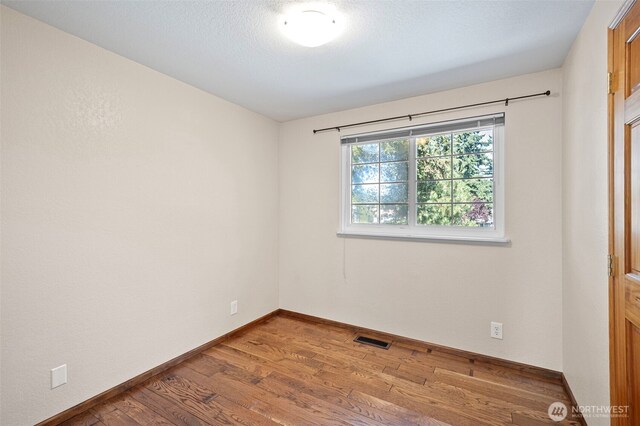 10122 50th Pl W, Mukilteo, WA 98275 - empty room featuring wood finished floors and baseboards