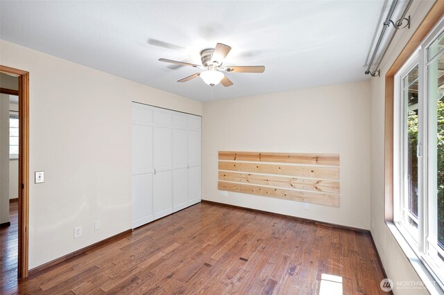 10122 50th Pl W, Mukilteo, WA 98275 - unfurnished bedroom with wood finished floors, a closet, and ceiling fan