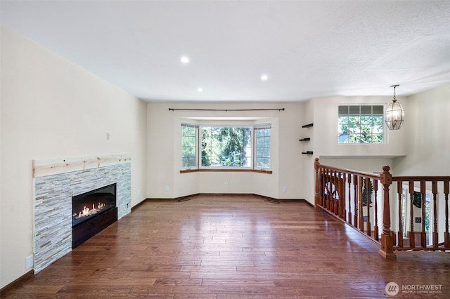 10122 50th Pl W, Mukilteo, WA 98275 - unfurnished living room with healthy amount of natural light, wood finished floors, a fireplace, and recessed lighting
