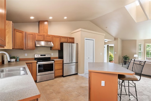 6401 151st St NW, Gig Harbor, WA 98332 - kitchen featuring stainless steel appliances, under cabinet range hood, a kitchen breakfast bar, light countertops, and lofted ceiling