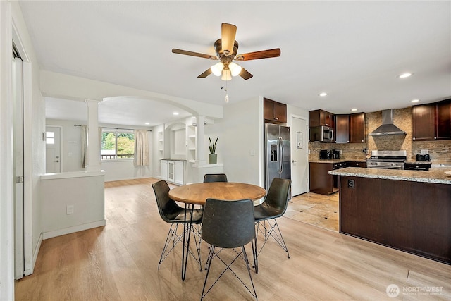 828 Gregory Way SE, Olympia, WA 98513 - dining space featuring decorative columns, a ceiling fan, light wood-type flooring, arched walkways, and recessed lighting