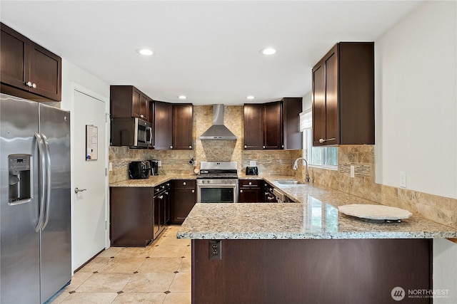 828 Gregory Way SE, Olympia, WA 98513 - kitchen featuring stainless steel appliances, wall chimney exhaust hood, dark brown cabinets, decorative backsplash, and light stone countertops