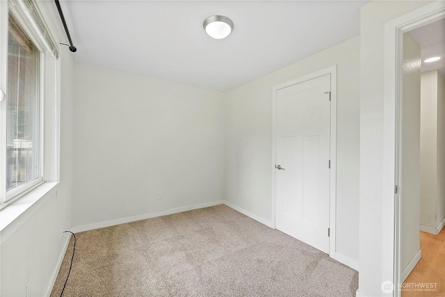 828 Gregory Way SE, Olympia, WA 98513 - unfurnished bedroom featuring light carpet and baseboards