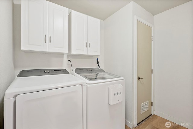 828 Gregory Way SE, Olympia, WA 98513 - laundry room featuring independent washer and dryer, cabinet space, and light wood-type flooring