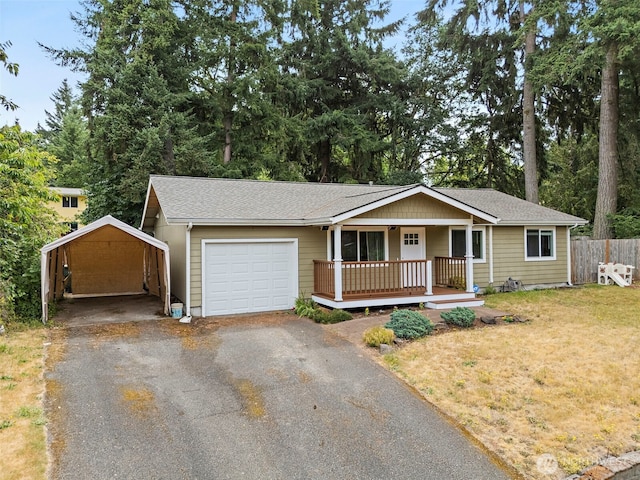 828 Gregory Way SE, Olympia, WA 98513 - ranch-style house featuring a carport, covered porch, driveway, a garage, and a shingled roof