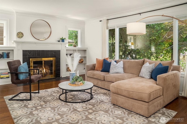6518 18th Ave NE, Seattle, WA 98115 - living room featuring ornamental molding, a tiled fireplace, and wood finished floors