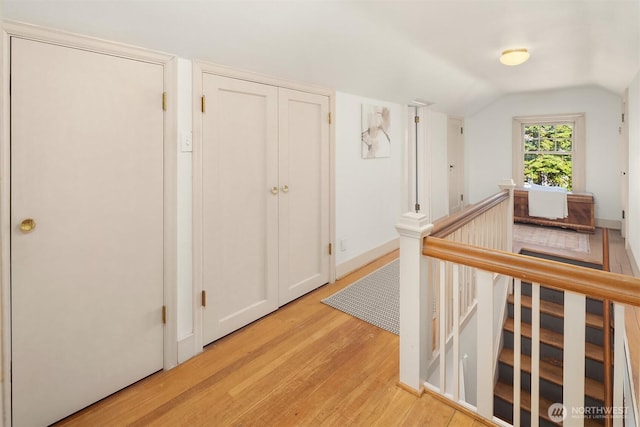 6518 18th Ave NE, Seattle, WA 98115 - hallway featuring an upstairs landing, light wood-style floors, and vaulted ceiling