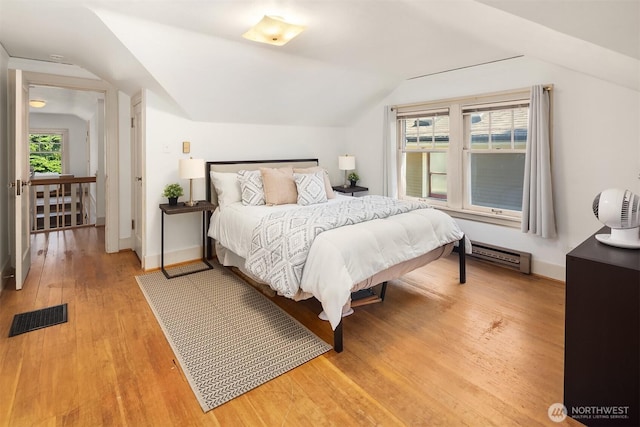 6518 18th Ave NE, Seattle, WA 98115 - bedroom featuring lofted ceiling, light wood finished floors, and a baseboard radiator