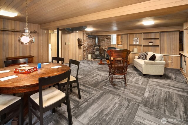 6518 18th Ave NE, Seattle, WA 98115 - dining space featuring a wood stove, wooden walls, wood ceiling, and carpet floors