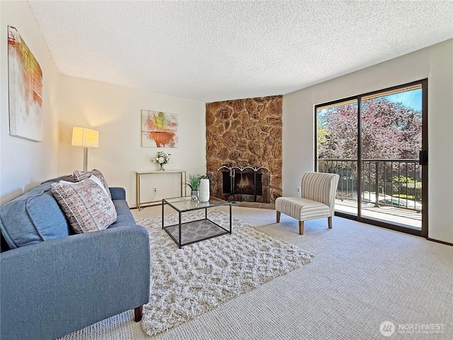 12611 NE 145th Pl Unit H85, Kirkland, WA 98034 - carpeted living area with a textured ceiling and a fireplace