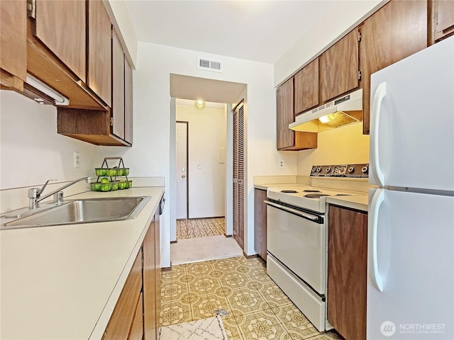 12611 NE 145th Pl Unit H85, Kirkland, WA 98034 - kitchen featuring white appliances, range hood, light countertops, and brown cabinets