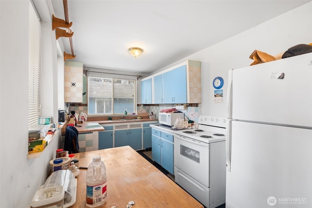 1869 Van Hoesen Rd, Onalaska, WA 98570 - kitchen featuring white appliances, blue cabinets, wooden counters, and water heater